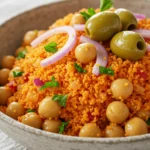 Bulgur wheat pilaf served with tomatoes, green olives, parsley, and red onions in a Mediterranean bowl